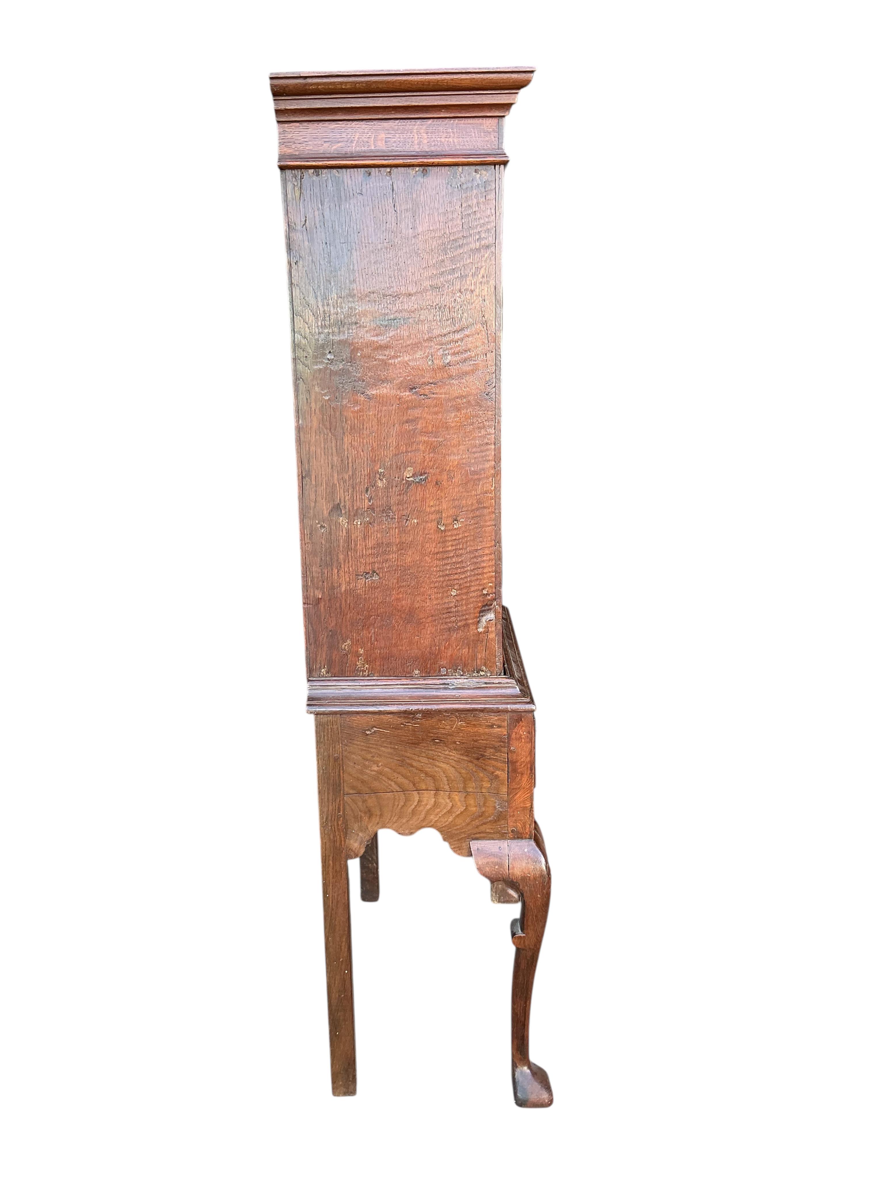 An 18th century and later inlaid oak cabinet on stand, width 72cm, depth 36cm, height 162cm